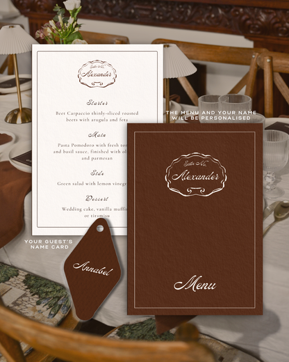 Personalized menu and name card set from The Suite by Imaginary Friends, displayed on a styled table with white plates, brown linen and ribbed glassware.